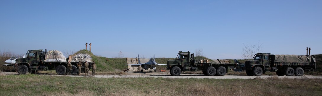 7-ton trucks loaded with ammunition, supplies and Marines from Weapons Company, 3rd Battalion, 8th Marines, are staged at an embarkation point during a contingency response drill.  Contingency response drills are designed to train Marines to be ready at a moment’s notice.  Black Sea Rotational Force 14 is a task force of Marines and sailors with the mission to sustain positive relationships with partner nations uphold regional stability and increase military operational capabilities while also proving the ability for rapid crisis response in the Black Sea, Balkan and Caucasus regions of Eastern Europe. (Official Marine Corps photo by Staff Sgt. Tanner M. Iskra, 2nd Marine Division Combat Camera, Black Sea Rotational Force/Released)