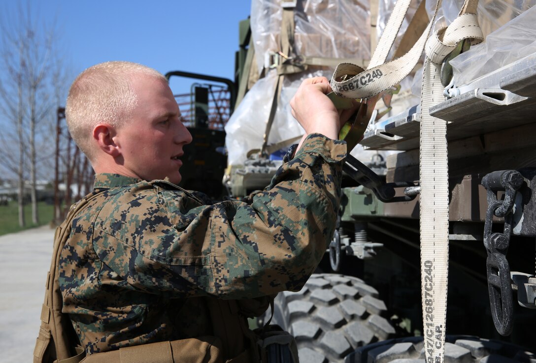 Lance Corporal Nathan Schulz, motor vehicle operator, Logistics Combat Element, 3rd Battalion, 8th Marines, assigned to Black Sea Rotational loosens a strap on a 7-ton truck during a contingency response drill.  Contingency respone drills are designed to train Marines to be ready at a moment’s notice.  Black Sea Rotational Force 14 is a task force of Marines and sailors with the mission to sustain positive relationships with partner nations uphold regional stability and increase military operational capabilities while also proving the ability for rapid crisis response in the Black Sea, Balkan and Caucasus regions of Eastern Europe. (Official Marine Corps photo by Staff Sgt. Tanner M. Iskra, 2nd Marine Division Combat Camera, Black Sea Rotational Force/Released)