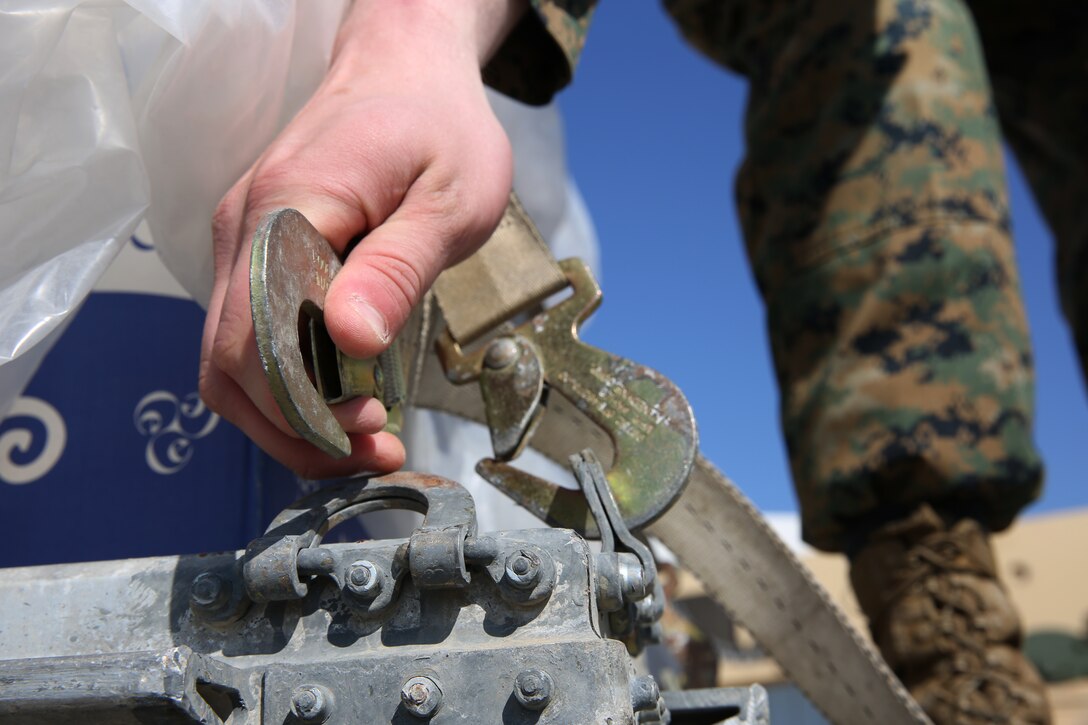 Sergeant Robert Reed, motor vehicle operator,  Logistics Combat Element, 3rd Battalion, 8th Marines unhooks a strap on a 7-ton truck during a contingency response drill.  Contingency response drills are designed to train Marines to be ready at a moment’s notice.  Black Sea Rotational Force 14 is a task force of Marines and sailors with the mission to sustain positive relationships with partner nations uphold regional stability and increase military operational capabilities while also proving the ability for rapid crisis response in the Black Sea, Balkan and Caucasus regions of Eastern Europe. (Official Marine Corps photo by Staff Sgt. Tanner M. Iskra, 2nd Marine Division Combat Camera, Black Sea Rotational Force/Released)