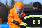 Staff Sgt. Jonathon Luis of the 103rd Civil Support Team, Alaska National Guard, observes his Soldier responding to scenario where an overturned rail car tanker is leaking hazardous material at the Anchorage Fire department training center rubble pile, Anchorage, Alaska, March 27, 2014.