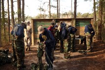 Dreher High School Navy Junior Reserve Officer Training Corps cadets don Mission Oriented Protective Posture (MOPP) suits during a period of instruction from chemical, biological, radiological and nuclear defense specialists with CBRN Platoon, Combat Logistics Regiment 27, 2nd Marine Logistics Group aboard Camp Lejeune, N.C., March 27, 2014. The cadets learned how to put the gear on, change the gear in a chemical environment, and the different capabilities the Marine Corps has to combat CBRN attacks.   (U.S. Marine Corps photo by Lance Cpl. Shawn Valosin)