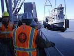 A U.S. Army tugboat is unloaded from the USNS Mendonca, a large cargo ship, during Alaska Shield 2014 in Anchorage, Alaska, March 27 2014. 