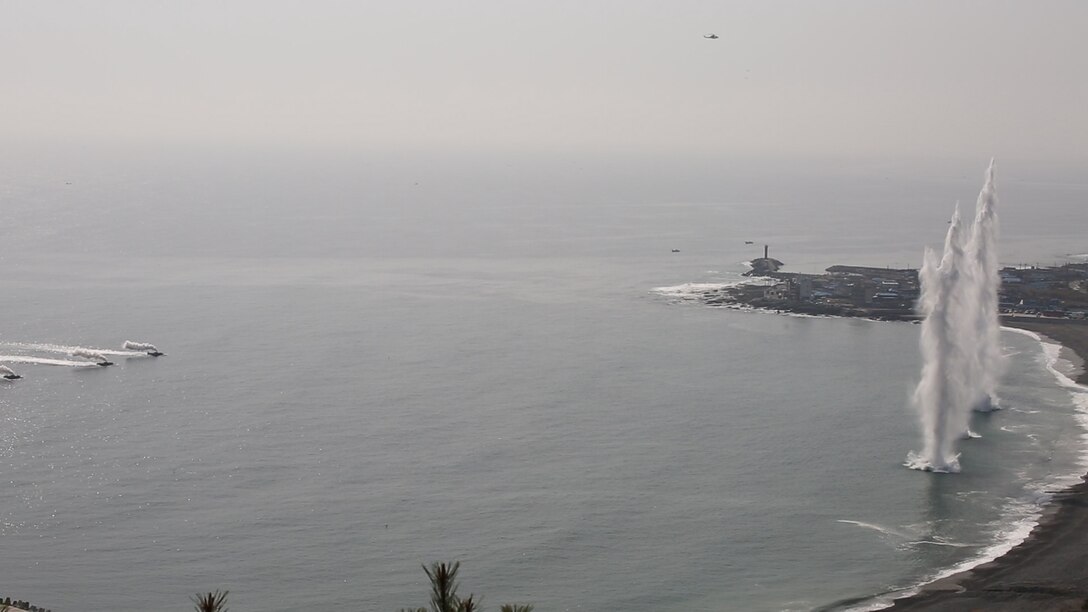 Republic of Korea and U.S. amphibious assault vehicles approach the shoreline as simulated naval bombardment rounds explode during the amphibious assault portion of exercise Ssang Yong 2014 at Dokseok-ri beach in Pohang, Republic of Korea March 31. Ssang Yong exercises the combined amphibious capabilities of the ROK and U.S. Marine Corps while demonstrating the maturity of the alliance. For the exercise, both the ROK and U.S. AAVs were commanded by the 3rd Marine Expeditionary Brigade, III Marine Expeditionary Force. (U.S. Marine Corps photo by Cpl. Matthew Manning/Released)