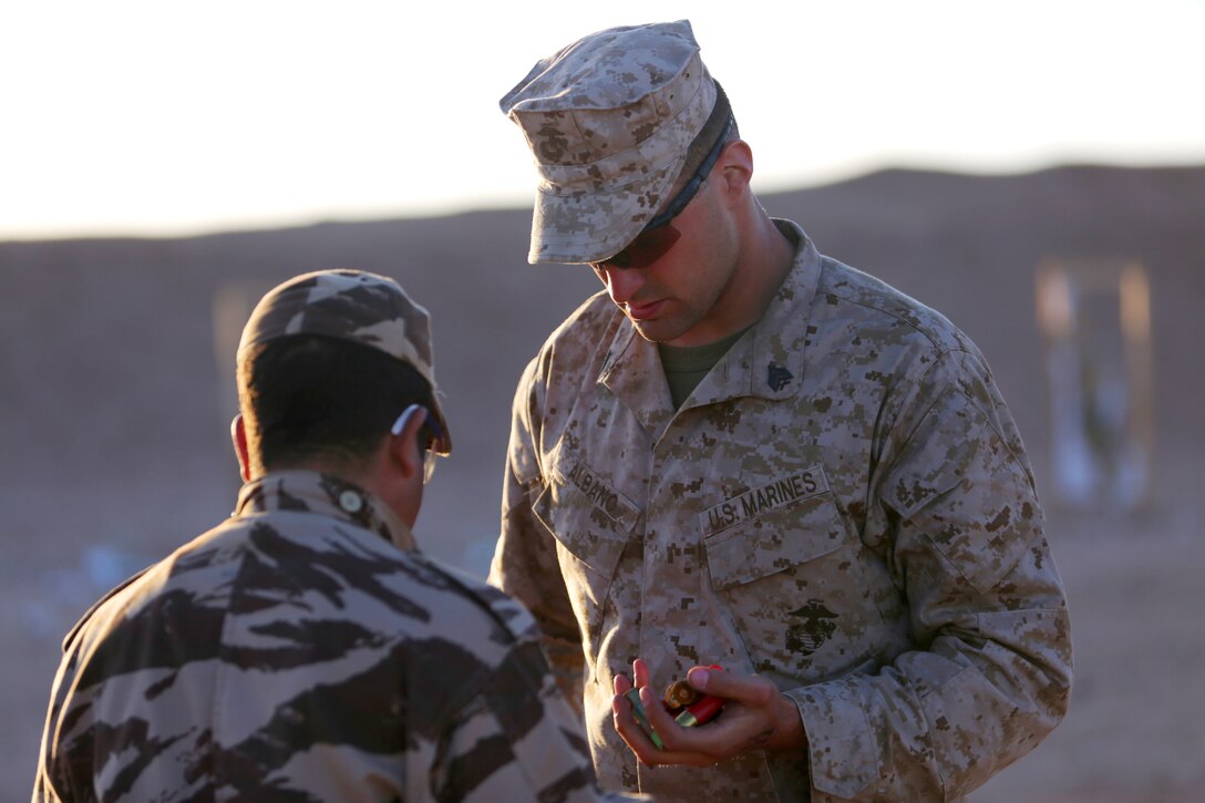 Counting foam baton rounds with his Royal Moroccan Armed Forces counterpart, Sgt. Matthew Albano, a military policeman with 2nd Law Enforcement Battalion and Dalton, Mass., native, prepares for a familiarization range with the Remington M500 shotgun. Nonleathal weapons employment and escalation-of-force operations are an integral part of military operations to prevent the loss-of-life while maintaining civil disorder. During the evolution, Royal Moroccan Armed Forces soldiers, and U.S. military policemen from the Marines, Army and Air Force combined to refine a share their escalation-of-force tactics and procedures while building military partnerships and international friendships. 
