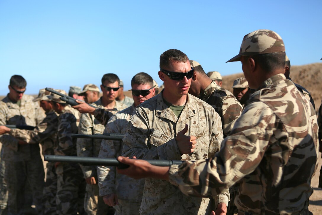 Corporal Jacob W. Swift, a military policeman with 2nd Law Enforcement Battalion, introduces the Remington M500 shotgun to a Royal Moroccan soldier during a nonlethal weapons familiarization range. Nonleathal weapons employment and escalation-of-force operations are an integral part of military operations to prevent the loss-of-life while maintaining civil disorder. During the evolution, Royal Moroccan Armed Forces soldiers, and U.S. military policemen from the Marines, Army and Air Force combined to refine a share their escalation-of-force tactics and procedures while building military partnerships and international friendships. 
