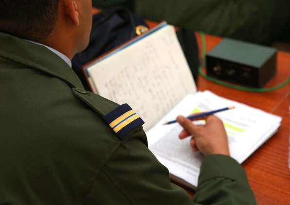 A Moroccan soldier takes notes during an intelligence capacity building workshop as a part of Exercise African Lion 2014.  Royal Moroccan intelligence personnel teamed up with U.S. Marines and German forces for a week to build understanding of the processes each use to gather information essential to a commander to make informed decisions on the battelfield. 

Exercise African Lion 14 is a multi-lateral and combined-joint exercise between the Kingdom of Morocco, the U.S. and other partner nations designed to strengthen relationships with participating countries by increasing understanding of each nation's military capabilities.  The military-to-military portion of the exercise includes: command-post exercises with humanitarian aid and disaster relief themes; stability operations, such as nonlethal weapons training and respond-to-crisis drills; and an intelligence capability-building workshop.
