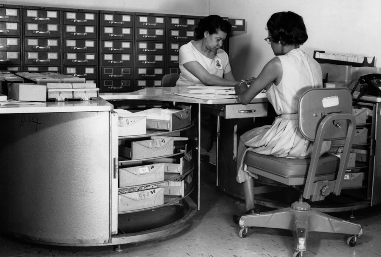 Aerial Film Control Files: Two clerks at work on aerial film control files at DIA in the 1960s. 