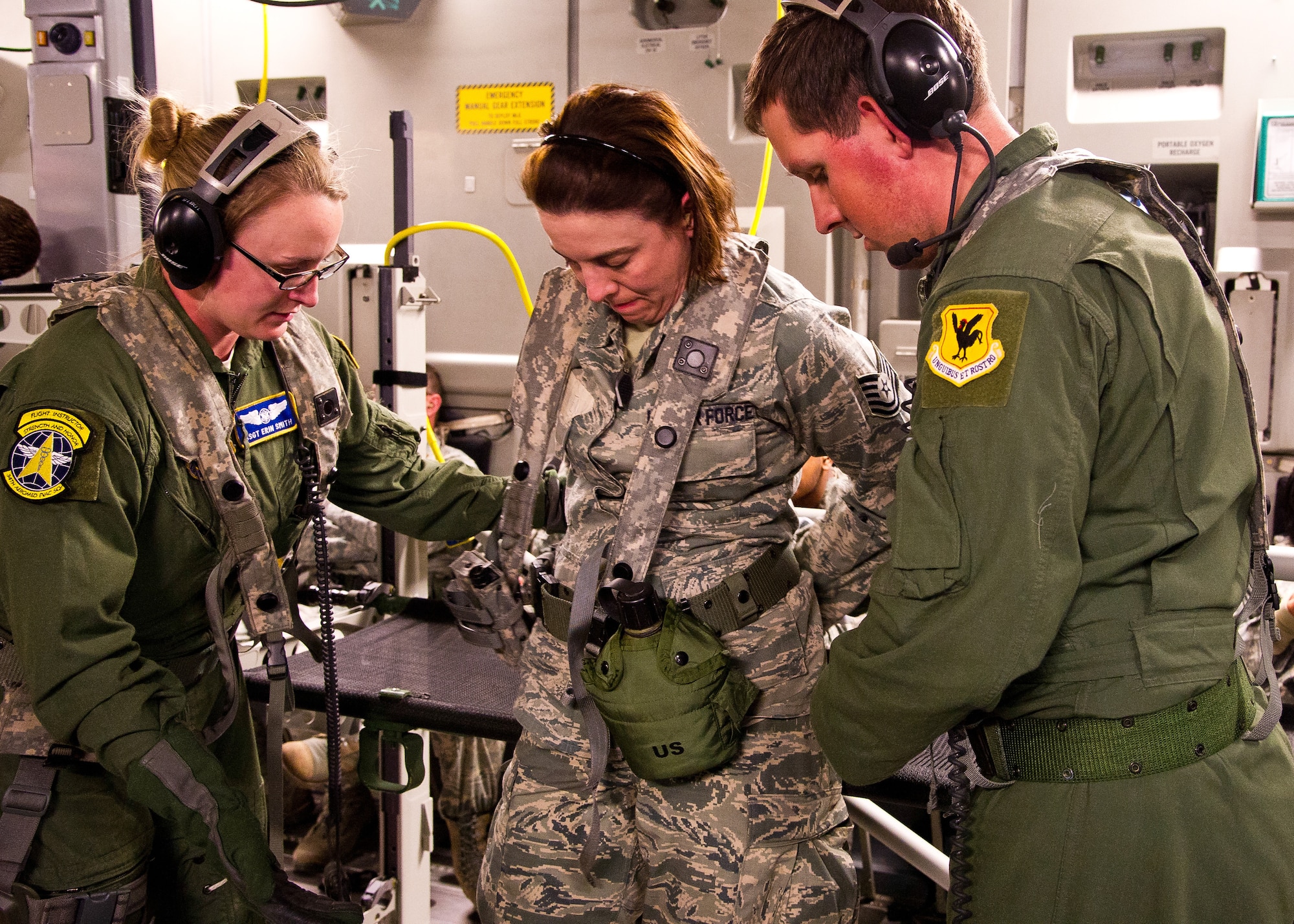 U.S. Air Force Staff Sgt. Erin Smith (left), aeromedical service journeyman, from the 34th Aeromedical Evacuation Squadron, Peterson Air Force Base, Colo., and Senior Airman Zachary Freeman (right), aeromedical service journeyman, from the 18th Aeromedical Evacuation Squadron, help simulated patient Tech. Sgt. Kristine Mayfield, medical service craftsman, from the 81st Medical Group, Keesler Air Force Base, Miss., down from a litter during a field exercise at the Joint Readiness Training Center (JRTC), Alexandria, La., March 13, 2014. Service members at JRTC 14-05 are educated in combat patient care and aeromedical evacuation in a simulated combat environment. (U.S. Air Force photo by Staff Sgt. Joseph Araiza)