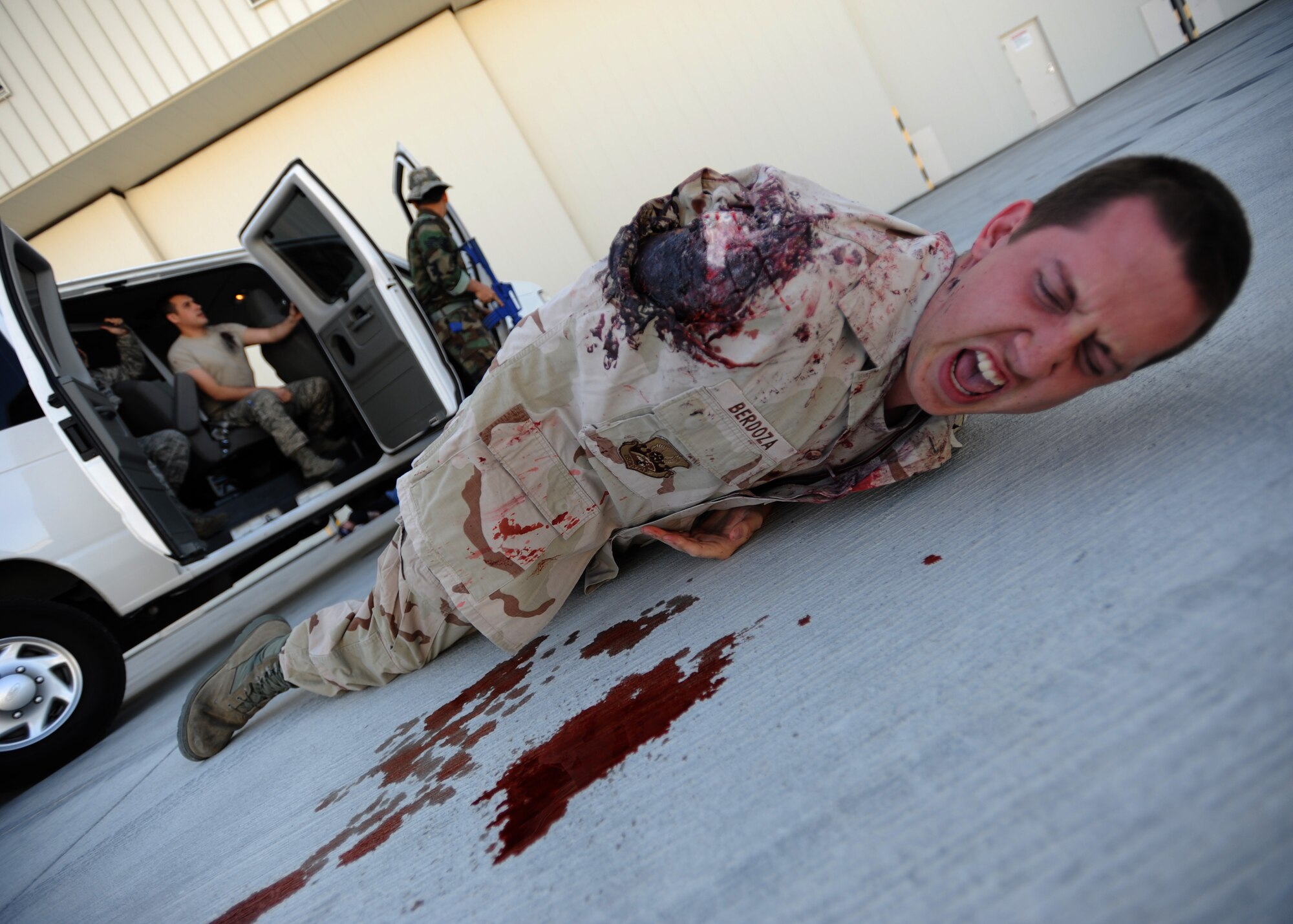 An Airman screams for help while wearing moulage to simulate losing an arm during an active shooter exercise at Creech Air Force Base, Nev., March 25, 2014. The exercise with Nellis Air Force Base, Nev., allowed first responders and medical personnel to receive realistic training. (U.S. Air Force photo by Staff Sgt. N.B./Released)