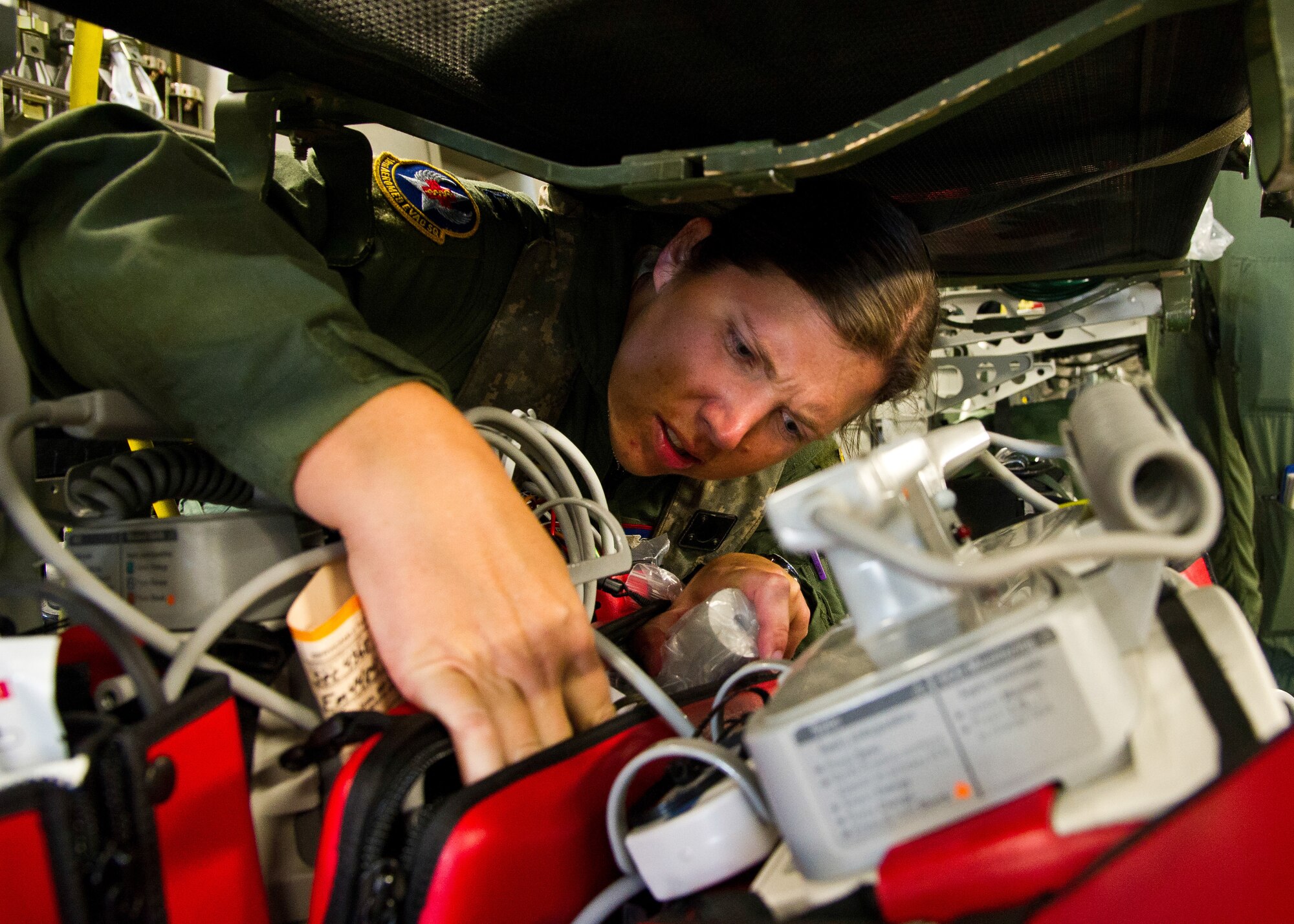 U.S. Air Force Capt. Noelle Deruiter, flight nurse, from the 18th Aeromedical Evacuation Squadron, Kadena Air Base, Okinawa, Japan, checks the defibrillator monitor during a field exercise at the Joint Readiness Training Center (JRTC), Alexandria, La., March 13, 2014. Service members at JRTC 14-05 are educated in combat patient care and aeromedical evacuation in a simulated combat environment. (U.S. Air Force photo by Staff Sgt. Joseph Araiza)