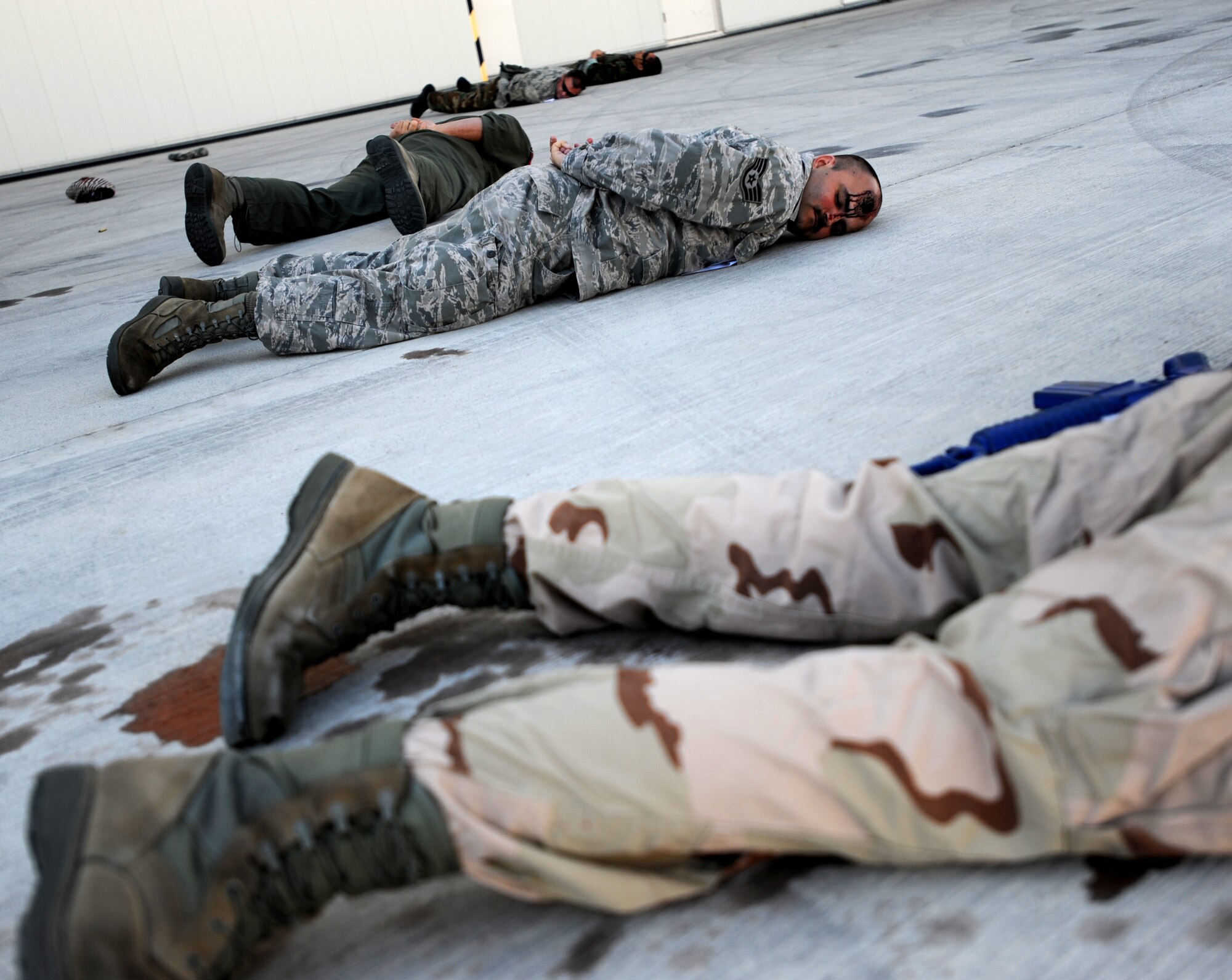 Simulated victims fill the scene of an active shooter exercise at Creech Air Force Base, Nev., March 25, 2014. Moulage is applied to Airmen acting as victims during the exercise to add an element of realism to allow accurate evaluation of medical personnel. (U.S. Air Force photo by Senior Master Sgt. C.R./Released)