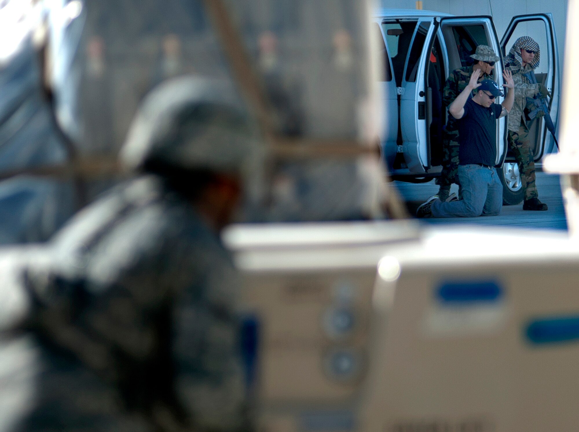 A security forces Airman evaluates the hostage situation during a simulated active shooter exercise at Creech Air Force Base, Nev., March 25, 2014. The exercise with Nellis Air Forces Base, Nev., tested the response capabilities of security forces first responders and their ability to manage and neutralize the threat during a real-world scenario. (U.S. Air Force photo by Senior Master Sgt. C.R./Released)