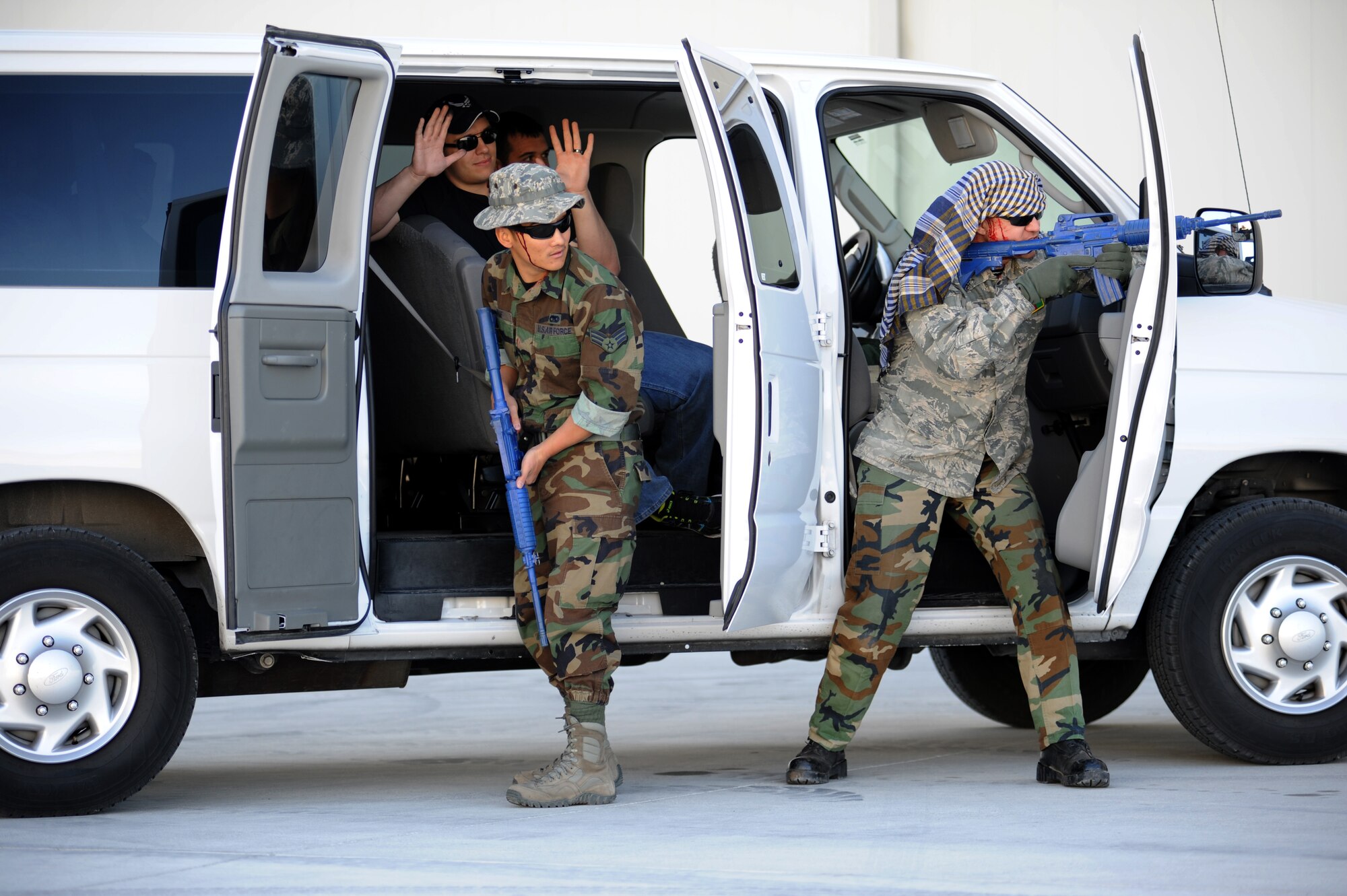 Simulated active shooters yell to security forces members arriving on scene during an exercise at Creech Air Force Base, Nev., March 25, 2014. Realistic exercise scenarios take place to test the capabilities of first responders to include medical and security forces personnel’s ability to respond to and neutralize a threat. (U.S. Air Force photo by Senior Master Sgt. C.R.)