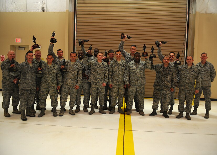 Maintenance Professional of the Year award winners stand with Col. James Mott, 16th Special Operations Squadron commander, March 21, 2014 at Cannon Air Force Base, N.M. The MPOY banquet is an annual event where the different squadrons in the 27th Special Operations Maintenance Group are given the chance to let loose and celebrate their fellow Air Commando’s achievements. (U.S. Air Force photo/Senior Airman Ericka Engblom)