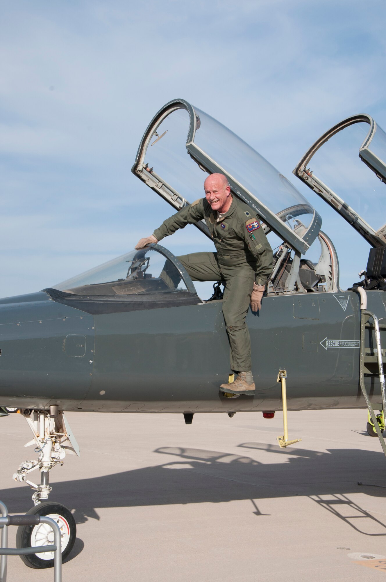 Lt. Col. Tom Kline, 87th Flying Training Squadron instructor pilot, dismounts a T-38 for the last time on Laughlin Air Force Base, Texas, March 20, 2014. Kline is the oldest active-duty instructor pilot for Air Education and Training Command and retired March 20, 2014. (U.S. Air Force photo/2nd Lt. Jhanelle Haag)  