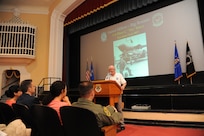 Retired Col. Elmo Baker, Prisoner of War from August 1967 to March 1973, speaks to an audience during the 41st Freedom Flyer event March 28 at the Joint Base San Antonio-Randolph Fleenor Auditorium. Annually, the Freedom Flyers return to JBSA-Randolph to share their stories and visit the site where they received their flying recertification, or their final flight, after their return from prisoner-of-war status. (U.S. Air Force photo by Melissa Peterson)