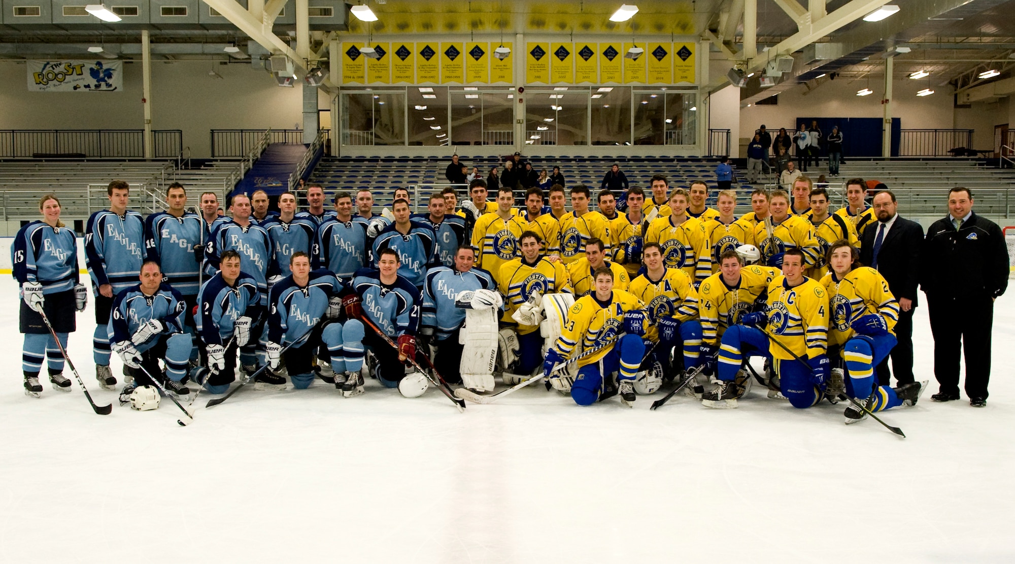The Dover Air Force Base Eagles and the University of Delaware Blue Hens, American Collegiate Hockey Association men’s division 2, hockey teams pose for a group photo March 23, 2014, at the Fred Rust Ice Arena on the University of Delaware campus in Newark, Del. The teams played each other in a charity game to raise money for the Fisher House Foundation. (U.S. Air Force photo/Airman 1st Class Zachary Cacicia) 