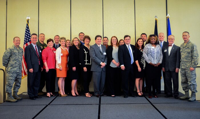 Col. Jeffrey DeVore, Joint Base Charleston commander (left), Col. Darren Hartford, 437th Airlift Wing commander (second from left), and Col. James Fontanella, 315th Airlift Wing commander (right), induct Charleston’s new Honorary Commanders during an Induction Ceremony March 28, 2014, at Joint Base Charleston - Air Base, S.C. The Honorary Commanders program educates local community leaders about the various missions at JB Charleston. (U.S. Air Force photo/ Senior Airman Tom Brading)