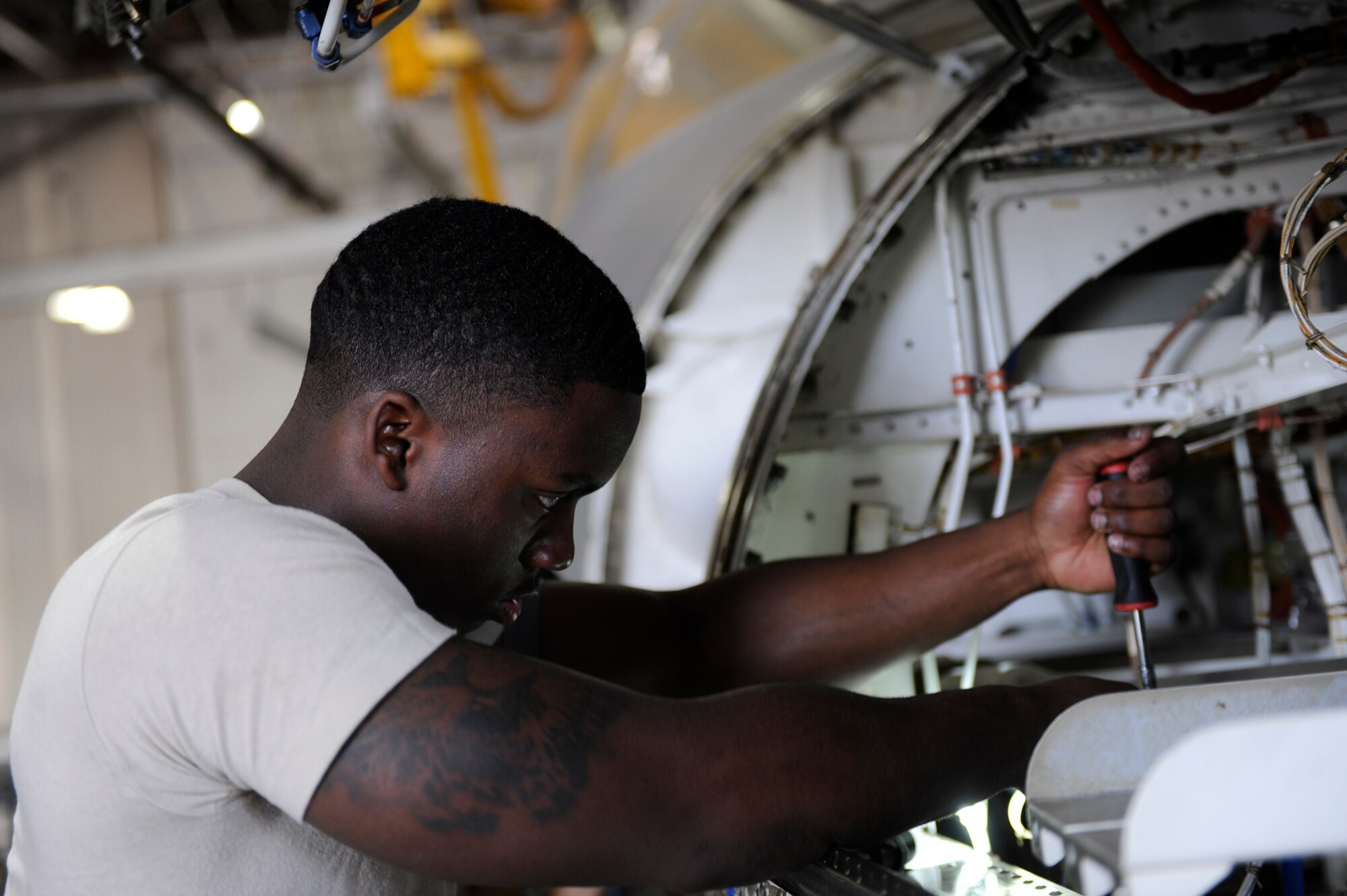 U.S. Air Force Airman 1st Class Corrie Hyman, 7th Equipment Maintenance Squadron, tightens brackets in the nose of a B-1B Lancer March 27, 2014, at Dyess Air Force Base, Texas.  The nose of the B-1 houses its radar which sweeps side-to-side within its housing to give navigators a detailed readout of the ground below. (U.S. Air Force photo by Airman 1st Class Alexander Guerrero/Released)