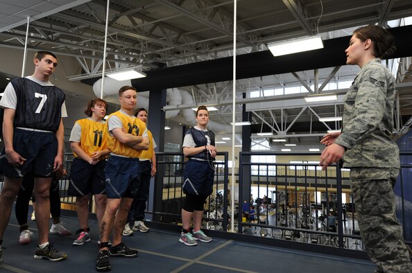 Senior Airman Guinevere Running Wolf briefs Airmen before the mile and a half run during the physical fitness test at Fairchild Air Force Base, Wash., March 27, 2014. Running Wolf is from the 92nd Force Support Squadron. The test consists of abdominal circumference measurement, a mile and a half timed run, and push-ups and sit-ups completed in one minute. (U.S. Air Force photo by Airman 1st Class Janelle Patiño/Released)