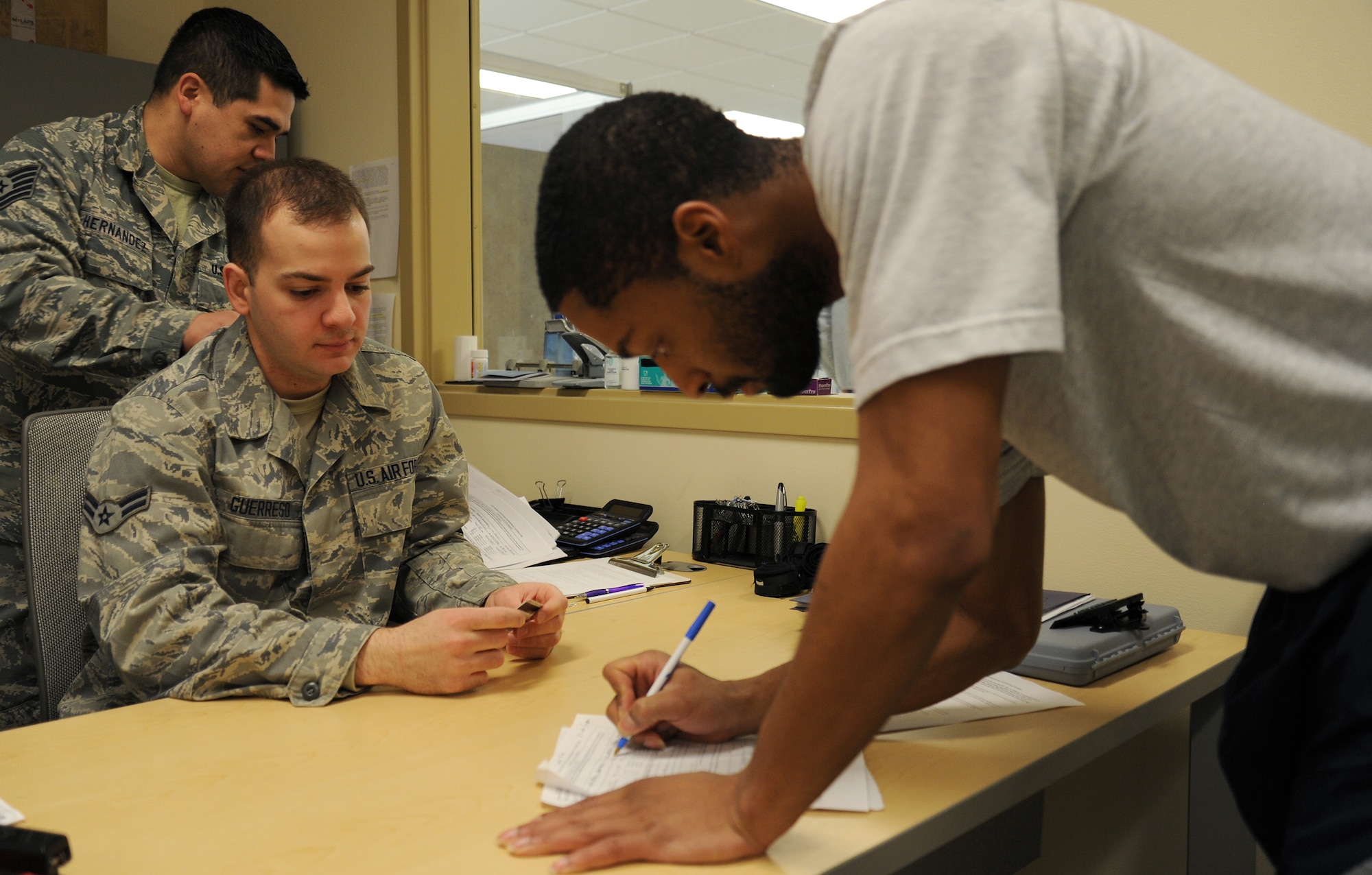 Airman 1st Class Justin Guerreso signs in Airmen before the physical fitness test at Fairchild Air Force Base, Wash., March 27, 2014. Guerreso, from the 92nd Air Refueling Wing Judge Advocate, was one of the physical fitness testers. PT tests are held Tuesdays and Thursdays at 8 a.m., 9 a.m.,10 a.m., 1:00 p.m. and 2 p.m. time slots. (U.S. Air Force photo by Airman 1st Class Janelle Patiño/Released)