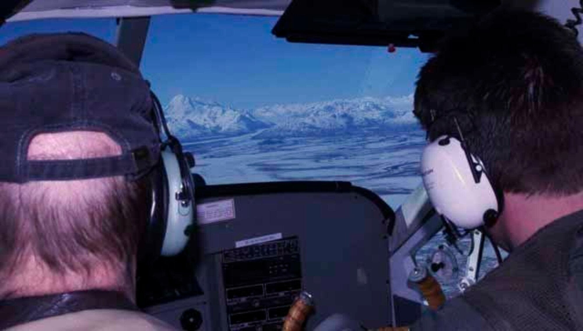 Ron Preston (right), a Civil Air Patrol mission pilot, flies on a damage assessment mission as part of Alaska Shield March 29, 2014. Jeff Morton (left), on a Civil Air Patrol mission, is a trained photographer/observer who photographs critical infrastructure such as energy facilities and then documents damage and sends the data to federal officials for analysis. Alaska Shield 14 is an exercise that involves state, federal, military, and local agencies, designed to test response and coordination efforts during a disaster and is modeled after the 1964 earthquake and subsequent tsunami that devastated much of South Central Alaska. (U.S. Army photo by Spc. Ryan A. Swanson)