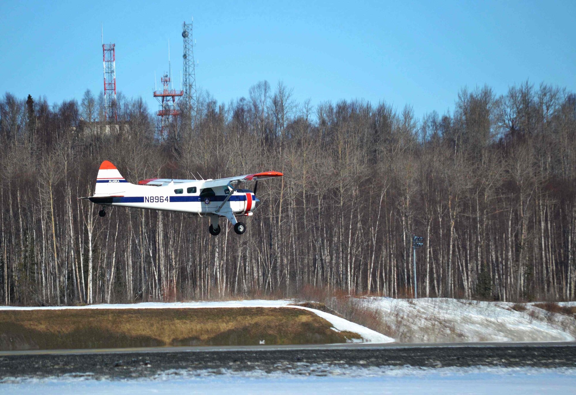 A Civil Air Patrol plane surveys an airstrip near the shores of the Cook Inlet, Alaska, during a mock exercise called Alaska Shield March 29, 2014. In the event a natural disaster, photographers are flown by Civil Air Patrol volunteers to key energy sites to assess damage and then provide their photos to the response leaders for analysis. Alaska Shield 14 is an exercise that involves state, federal, military, and local agencies, designed to test response and coordination efforts during a disaster and is modeled after the 1964 earthquake and subsequent tsunami that devastated much of South Central Alaska. (Photo by James Sommerville)