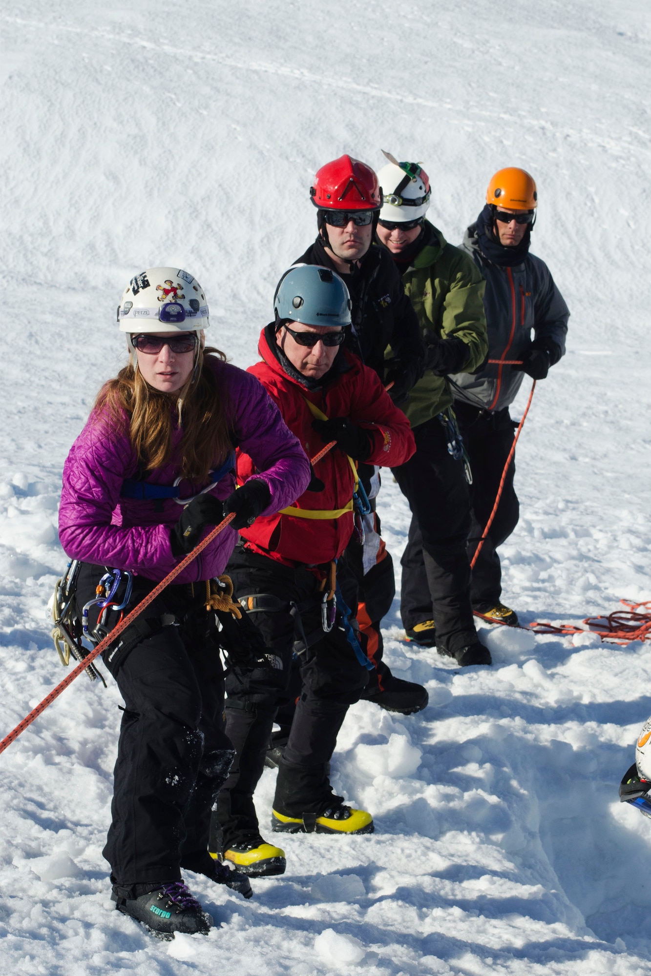Jennifer Weber, a volunteer with the Valdez Fire Department's Back Country Rescue team, along with local rescue members, pulls out a simulated casualty while performing a glacier rescue during Alaska Shield 14 here, March 30, 2014. Alaska Shield 14 is an exercise that involves federal, state, local, and military agencies, designed to test response and coordination efforts during a disaster and is modeled after the 1964 earthquake and subsequent tsunami that devastated much of South Central Alaska including the city of Valdez. (U.S. Army photo by Spc. True Thao)