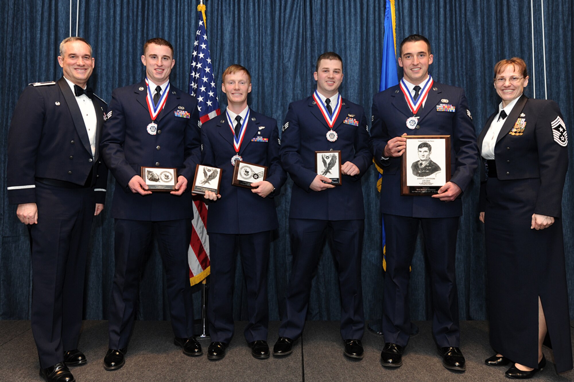 Col. Brian Newberry, 92nd Air Refueling Wing commander, and Chief Master Sgt. Wendy Hansen, 92nd ARW command chief, pose for a photo with the Airman Leadership School award winners at Fairchild Air Force Base, Wash., March 28, 2014. ALS award winners include Senior Airman Michael Bilodeau, 66th Training Squadron, Senior Airman Brian Doyle, 36th Rescue Flight, Senior Airman Jeffrey Watson, 92nd Air Refueling Squadron, and Senior Airman Austin Reeh, 92nd Aircraft Maintenance Squadron. (U.S. Air Force photo by Airman 1st Class Janelle Patiño/Released)