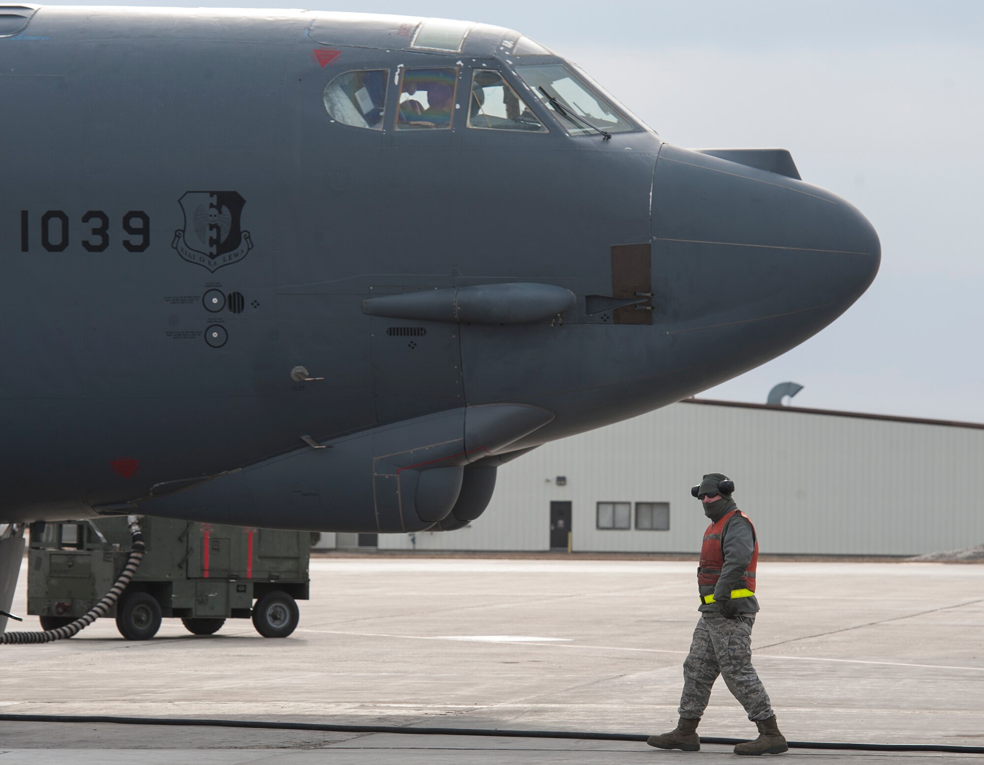 A crew chief checks the area around a B-52H Stratofortress just before it taxied to takeoff from Minot Air Force Base, N.D., March 27, 2014. A group of B-52s travelled to Ellsworth AFB in preparation for runway construction that is slated to begin in early April and scheduled to be completed by September.  (U.S. Air Force photo/Senior Airman Andrew Crawford