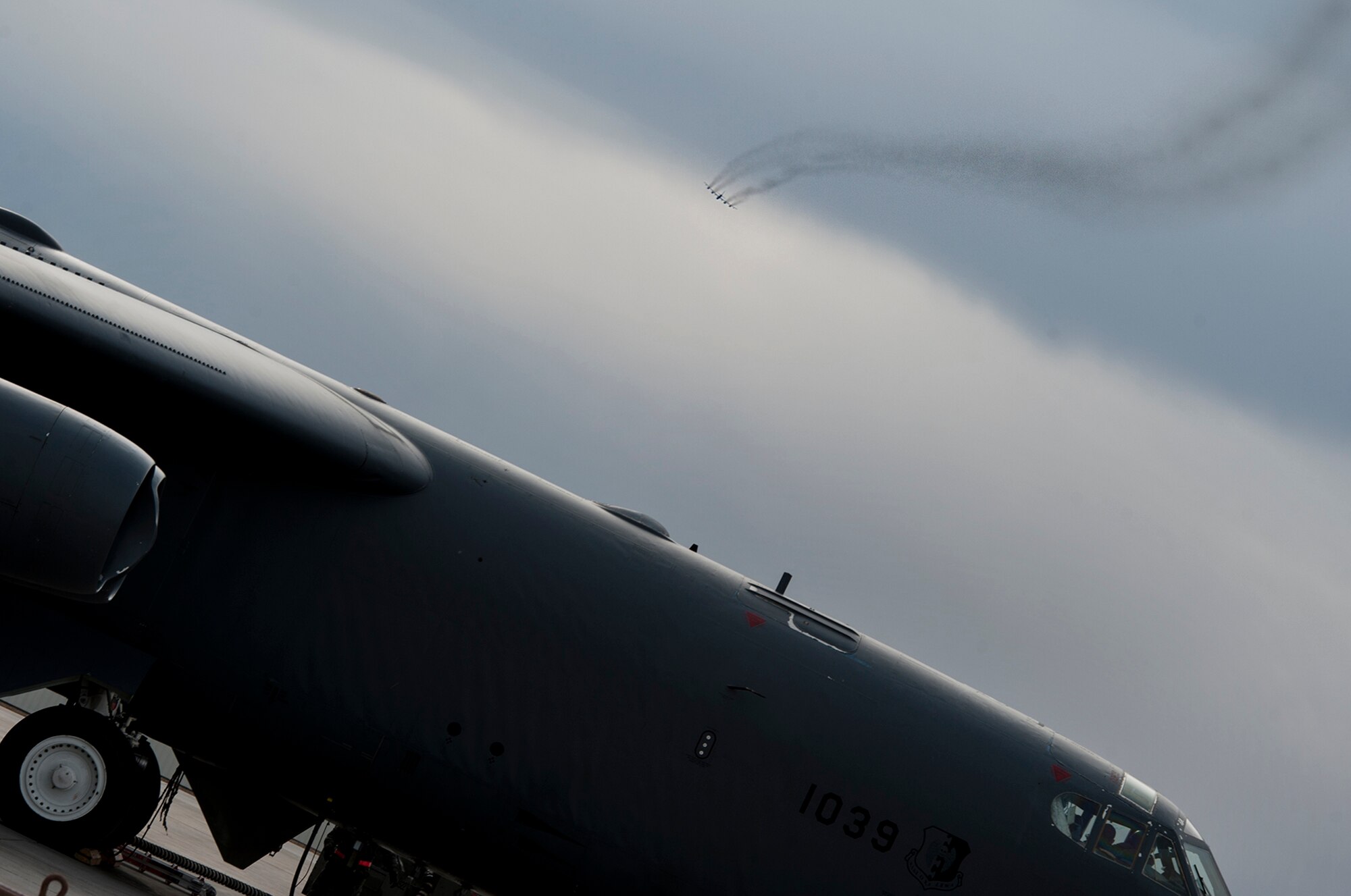 Streams of smoke from a B-52H Stratofortress are etched in the sky at Minot Air Force Base, N.D., March 27, 2014. The final phase of Minot AFB’s runway reconstruction project is scheduled to begin in early April and will cost approximately $32.8 million. (U.S. Air Force photo/Senior Airman Andrew Crawford)