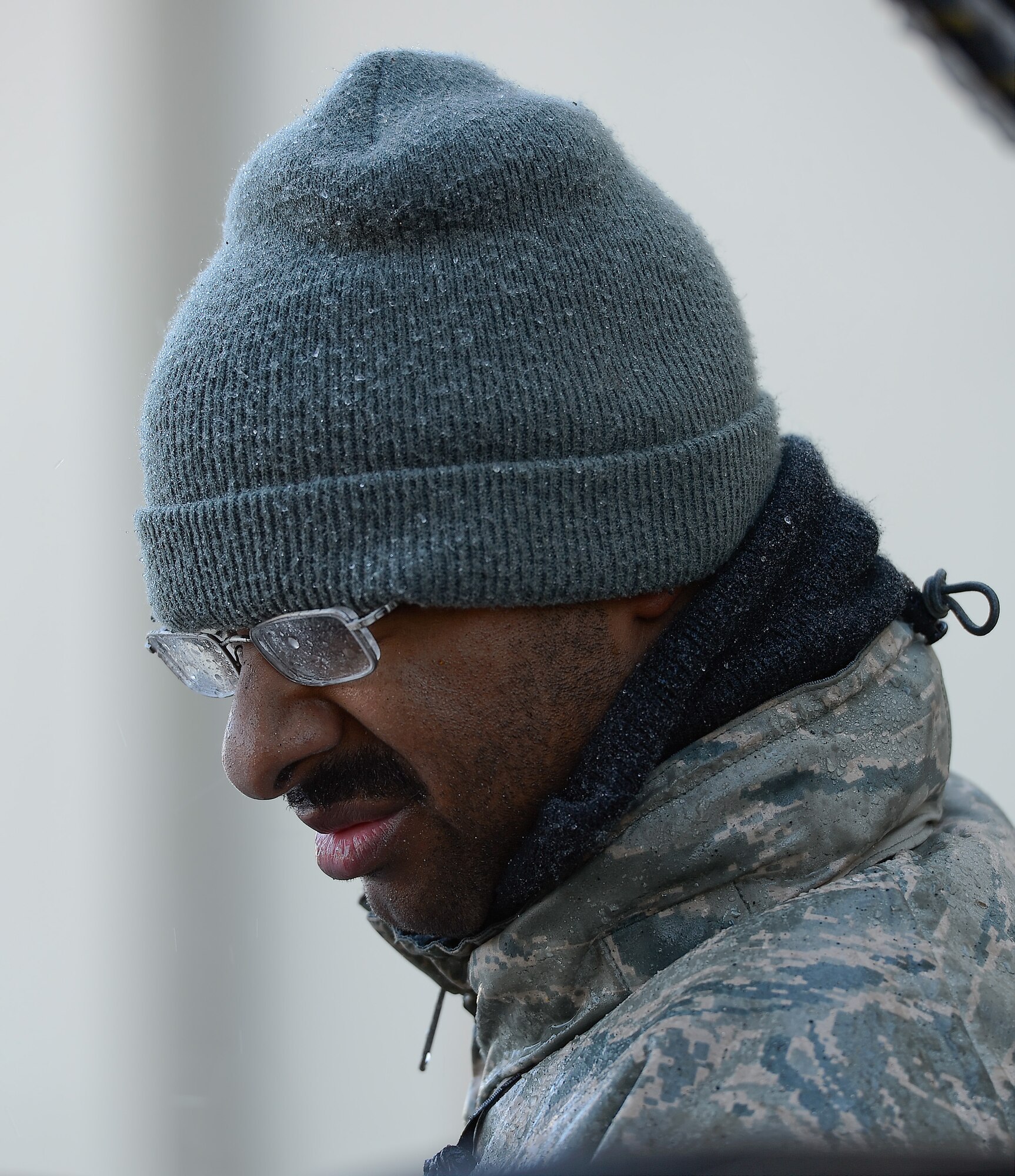 Airman 1st Class Ernest Gilmore, 436th Civil Engineer Squadron, pressure washes a piece of snow removal equipment using heated water on March 20, 2014, at Dover Air Force Base, Del. Water droplets that have splashed up during the work can be seen on A1C Gilmore???s glasses. (U.S. Air Force photo/Greg L. Davis)