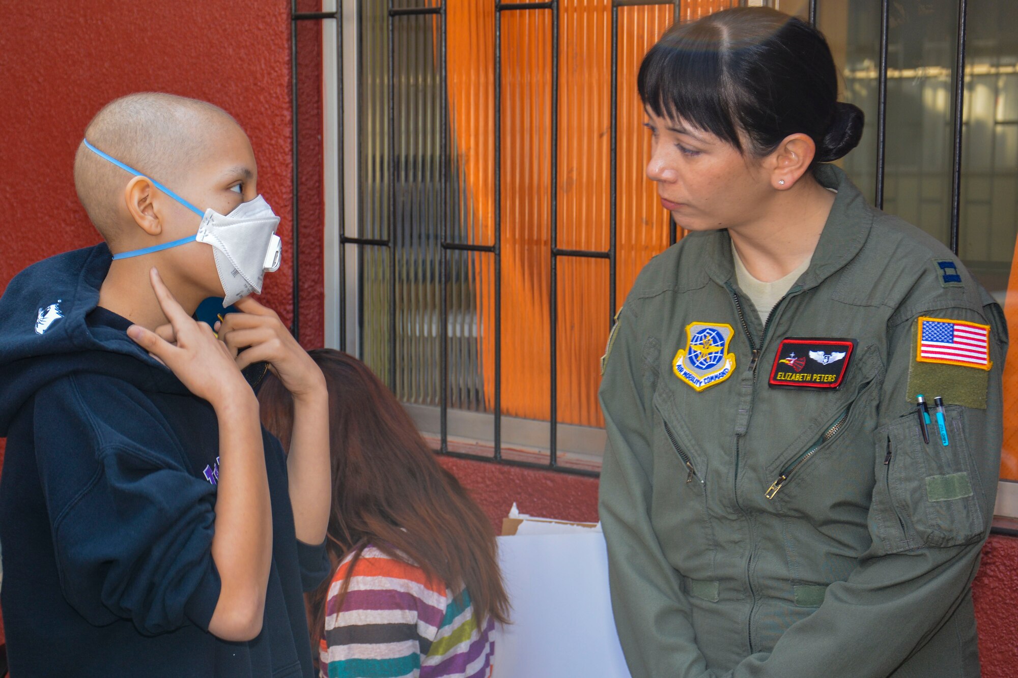 Capt. Elizabeth Peters, Aeromedical Evacuation Air Adviser for the 571st Mobility Support Advisory Squadron, speaks with a Chilean child while visiting local hospital in Santiago, Chile, March 28. Nearly 60 U.S. airmen are on a temporary duty assignment in Chile to participate in subject matter expert exchanges with Chilean air force counterparts and host static displays of the C-130 Hercules and F-16 Fighting Falcon at the FIDAE Air Show March 25 to 30.  Participants in the visit met with more than 20 children at the hospital receiving long-term care and spent time coloring, building small airplanes and playing. (U.S. Air Force photo by Capt. Justin Brockhoff/Released)
