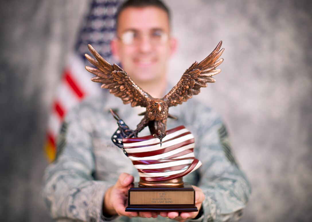 Chief Master Sgt. Craig LeDoux holds the AFDW Squadron of the Year trophy.
LeDoux led the Band as its chief enlisted manager during the period covered
by the award. (U.S. Air Force photo by Senior Master Sgt. Kevin Burns;
released)
