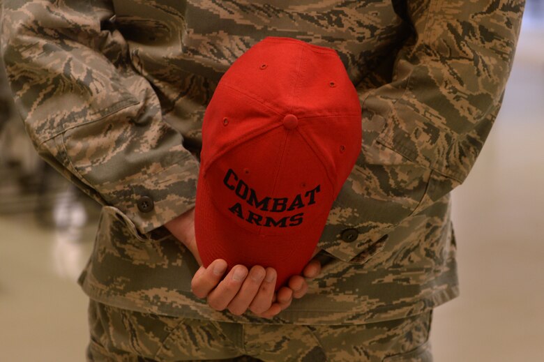 A Combat Arms instructor assigned to the 52nd Security Forces Squadron holds his cover behind his back during a ribbon cutting ceremony of the newly-finished Combat Arms facility at Spangdahlem Air Base, Germany, March 28, 2014. The CATM team qualified nearly 4,400 personnel by using six local ranges during the time of the range’s closure. (U.S. Air Force photo by Senior Airman Alexis Siekert)