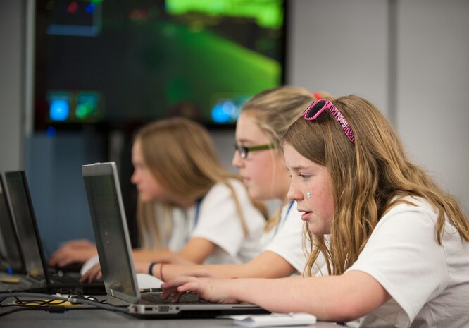 Middle school students compete in DimensionU games under the watchful eye of SPAWAR Systems Center Atlantic coaches at SPAWAR Systems Center Atlantic, March 28, 2014, on Joint Base Charleston – Weapons Station. The Tri-County DimensionU competition pitted more than 90 students from eight local middle schools in a competition testing their math and science skills in online, multi-player educational video games. (U.S. Navy photo/Joe Bullinger)