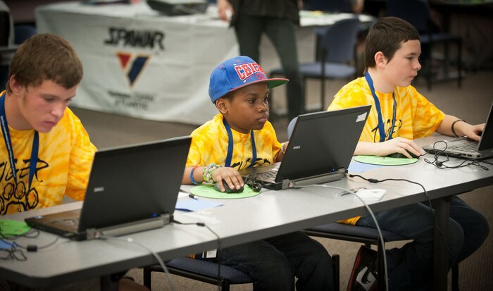 First place winner Jason Yeung of Hanahan Middle School ¬shows off his certificate and poses with fellow students and members of the SPAWAR Systems Center Atlantic STEM outreach team after the Tri-County DimensionU competition March 28, 2014, which pitted more than 90 students from eight local middle schools in a competition testing their math and science skills in online, multi-player educational video games. (U.S. Navy photo/Joe Bullinger)