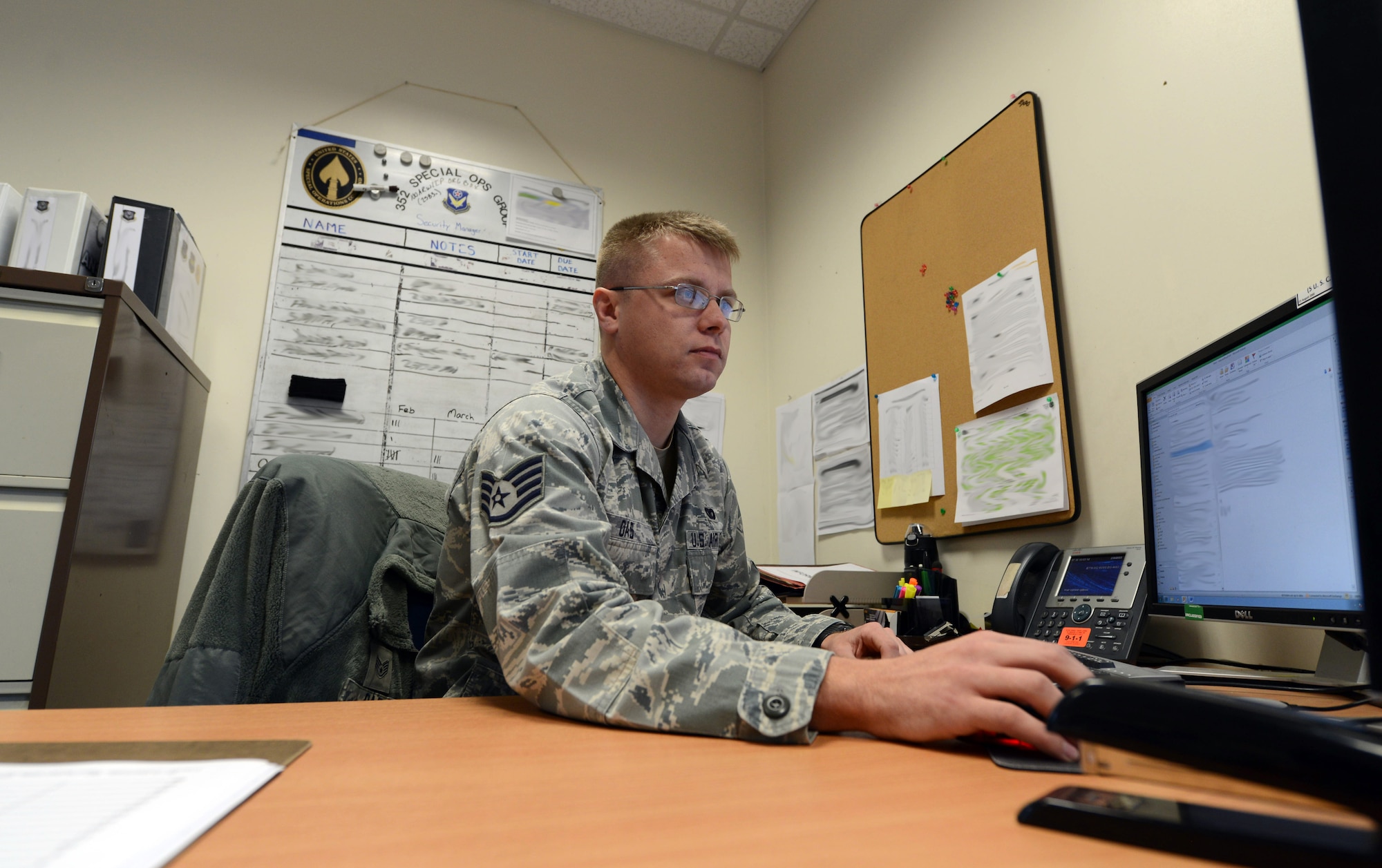 U.S. Air Force Staff Sgt. Craig J. Oas, 352nd Special Operations Support Squadron Security Forces Fly-Away Security Team member from Munising, Mich., manages the information security program March 13, 2014, on RAF Mildenhall, England. Oas earned the Square D Spotlight for exhibiting the Air Force core value of Excellence in All We Do. (U.S. Air Force photo by Airman 1st Class Kyla Gifford/Released)