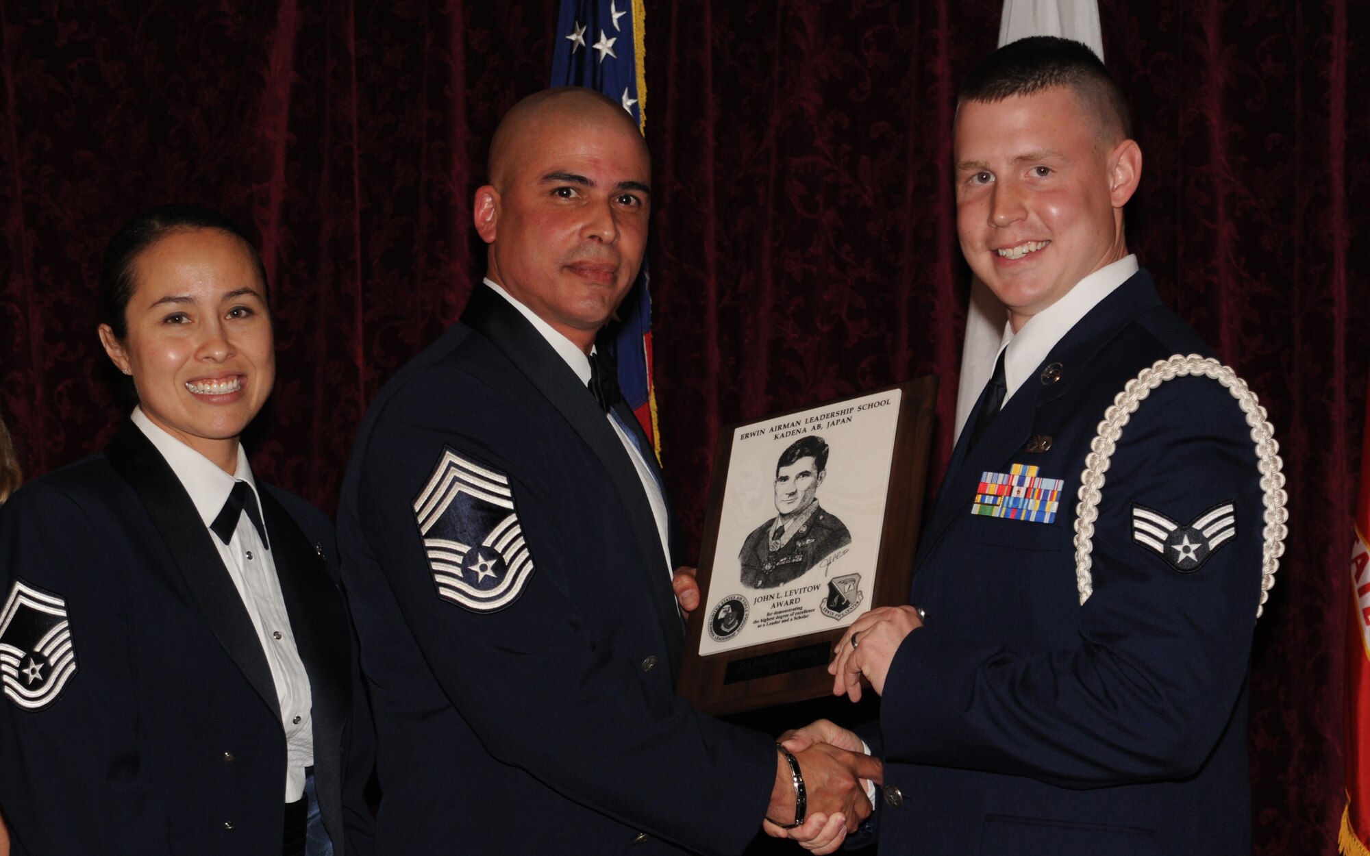 U.S. Air Force Senior Airman Joshua D. Whiting, 718th Aircraft Maintenance Squadron HH-60 space communication/navigation  systems specialist, accepts the John L. Levitow Award during the graduation ceremony for ALS Class 14-C on Kadena Air Base, Japan, March 27, 2014. The John L. Levitow Award is presented to the student who earns the highest average score on evaluations and most embodies the Air Force core values. (U.S. Air Force photo by Airman 1st Class Zackary A. Henry)