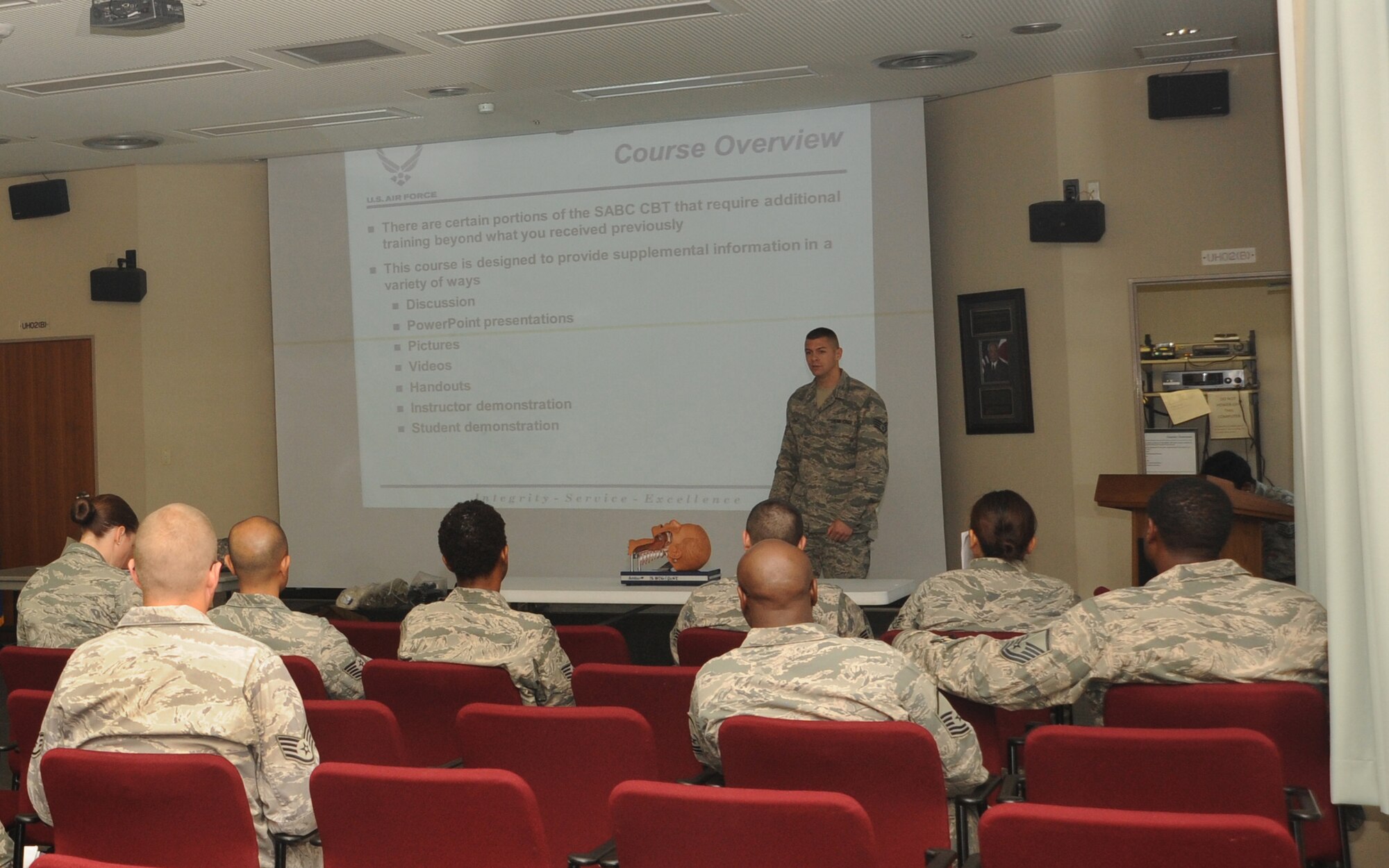 U.S. Air Force Staff Sgt Dennis Lolley, 2nd Reconnaissance Squadron transportation management office trainer, speaks to students during a self-aid and buddy care class on Kadena Air Base, Japan, March 27, 2014. Airmen are required to take the hands-on portion of the training every two years or before a deployment. The class provides Airmen an opportunity to learn how to manage injuries until help arrives. (U.S. Air Force photo by Airman 1st Class Zackary A. Henry)