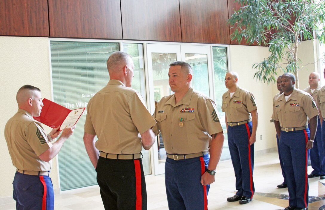 U.S. Marine Corps Staff Sgt. Jefferson Brink, a recruiter with Recruiting Sub-Station Richmond South and Eureka, Calif. native, shakes the hand of U.S. Marine Corps Maj. Gen. Mark Brilakis, Marine Corps Recruiting Command Commanding General, after he was awarded the Navy and Marine Corps Achievement Medal at Recruiting Station Richmond, April 28, 2014. Brink was awarded the medal for his superb commitment and drive during RS Richmond’s Operation Warrior, which was designed to increase the number of reservists contracted into the Delayed Entry Program. Brink thanked his team from RSS Richmond South, saying that success on recruiting duty is a team effort. (U.S. Marine Corps photo by Cpl. Aaron Diamant/Released)