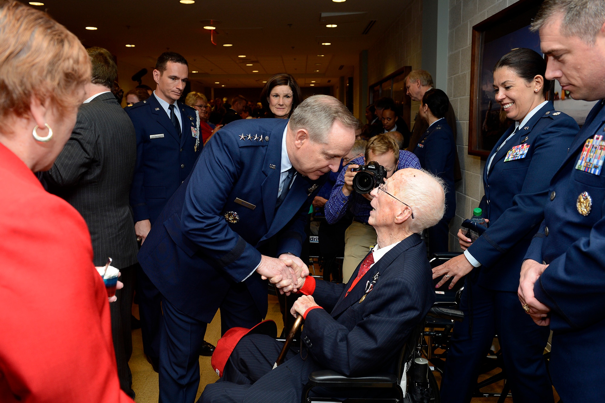 First Lt. James Mahon (seated) is congratulated by Air Force Chief of Staff Gen. Mark A. Welsh III after he received the Prisoner of War Medal April 30, 2014, during a ceremony at the Pentagon. Mahon was held in a prison camp in Wauwilermoos, Switzerland, after being shot down during a mission over Germany. (U.S. Air Force photo/Scott M. Ash)           
