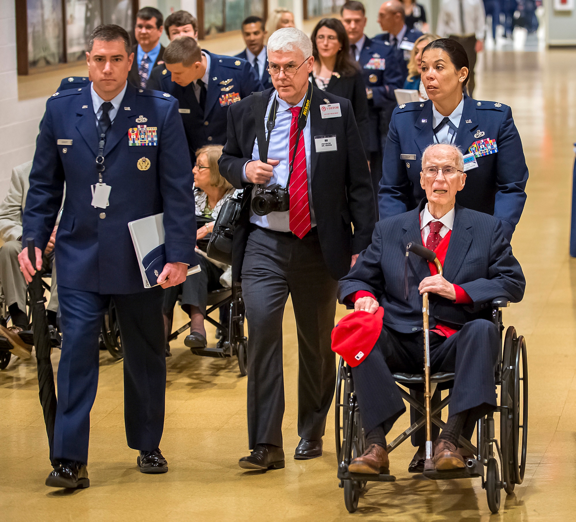 First Lt. James Mahon (seated) is escorted into the Pentagon where he received the Prisoner of War Medal from Air Force Chief of Staff Gen. Mark A. Welsh III during a ceremony April 30, 2014. Nine aviators were shot down while flying missions over Germany and held in a prison camp in Wauwilermoos, Switzerland. (U.S. Air Force photo/Jim Varhegyi)