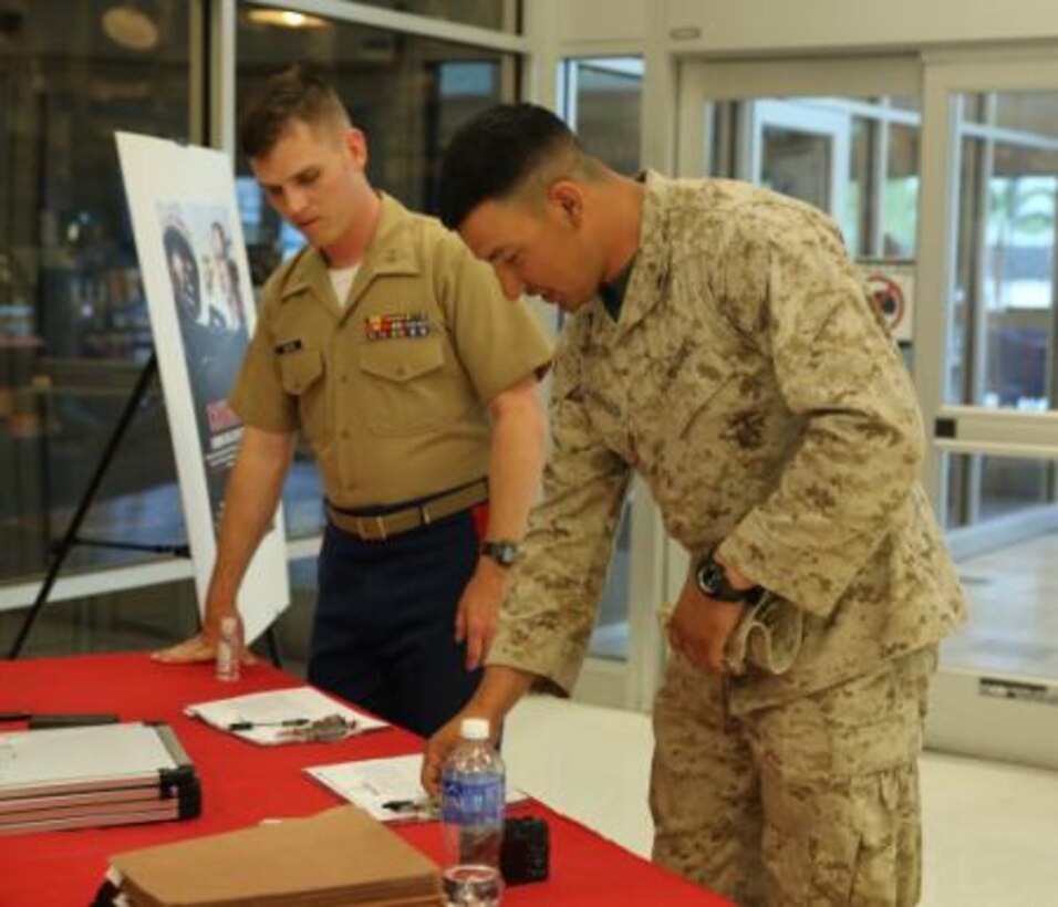 Capt. Wesley Jagoe, advertising operations officer, Marine Corps Recruiting Command, prepares to screen Cpl. Zachary Corrales, Marine, 1st Battalion, 7th Marine Regiment, during the Marine Corps Recruiting Command consolidated casting call held at the base exchange, Twentynine Palms April 25, 2014. According to Jagoe, more than 50 Marines applied for casting.