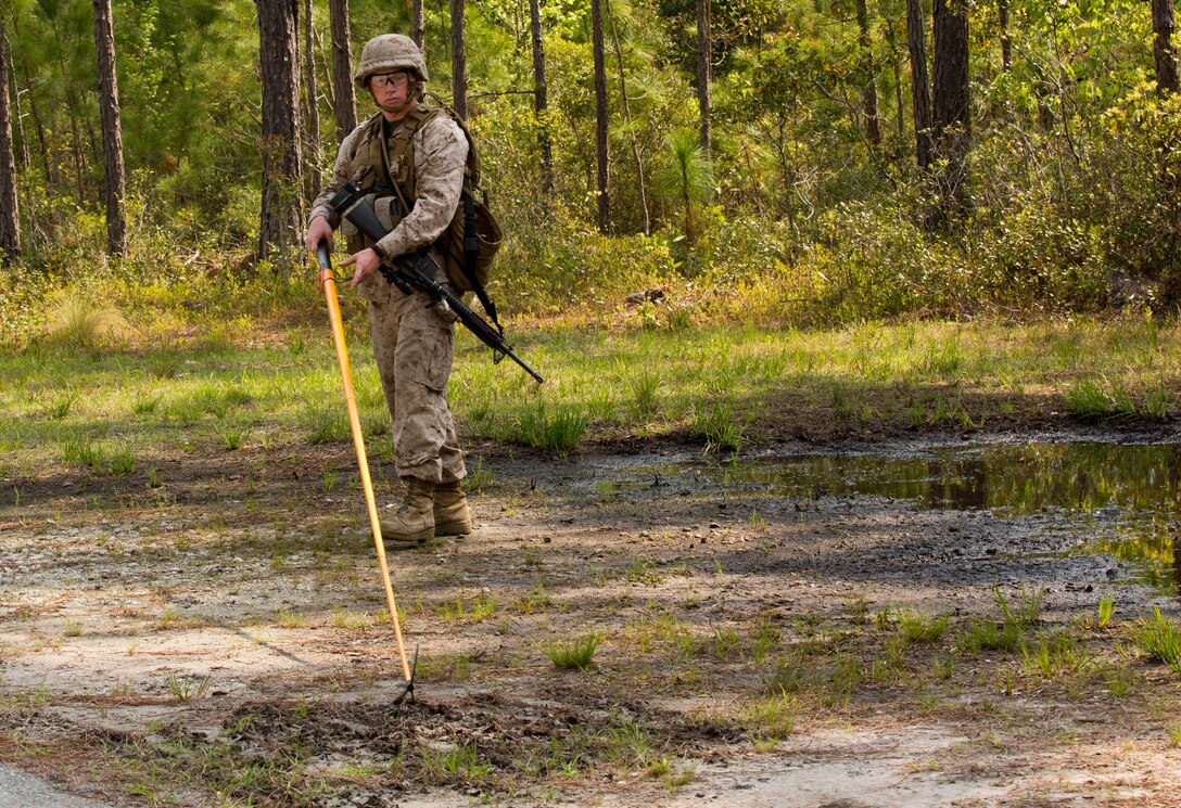 Pfc. Ryan Haselton, a combat engineer with Bravo Company, 2nd Combat Engineer Battalion’s, searches for improvised explosive device indicators with a Holley stick during a counter IED course held at the Marine Corps Engineer School’s Home Station Training Lanes in Holly Ridge, N.C., April 25. The training area has 4.5 kilometers of roads with overpasses, round-abouts, intersections and two villages.