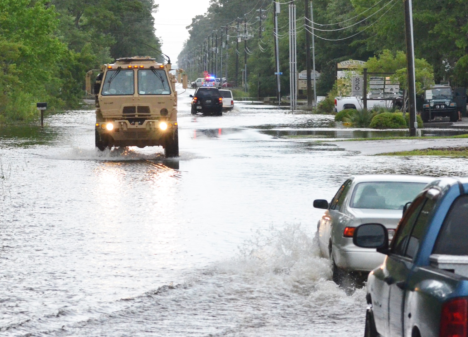 Soldiers in a high-water military vehicle from the Florida National Guard's 144th Transportation Company make their way through flooded roads near Santa Rosa Beach, Fla., April 30, 2014. More than 50 Florida Army National Guard Soldiers responded with high-water military vehicles to assist civilian first responders during flooding in Florida's panhandle.