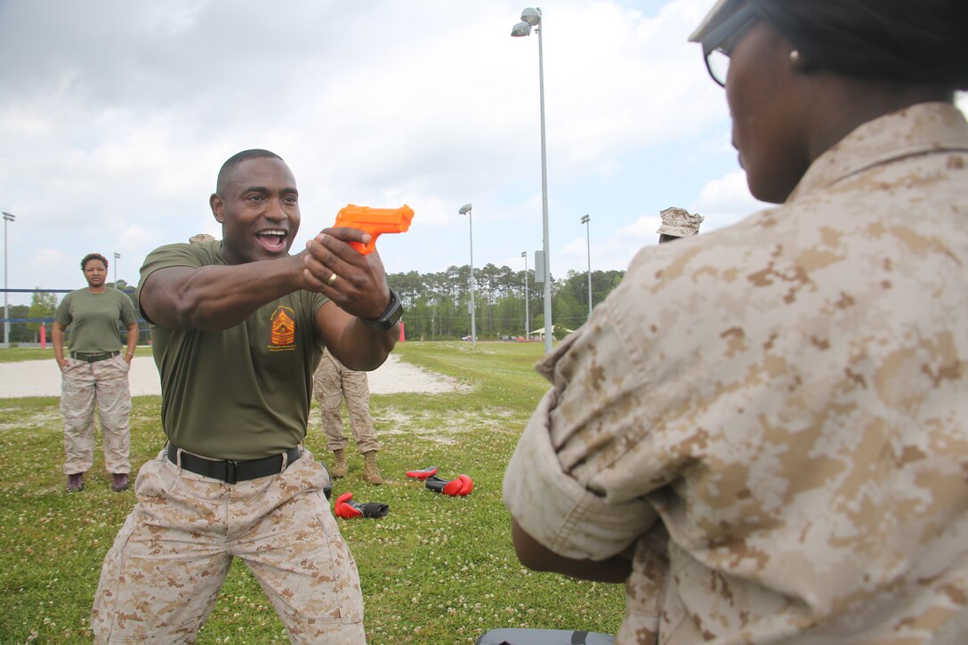 Gunnery Sgt. Maurice L. Irvin, the operations chief of Marine Aviation Logistics Squadron 14, demonstrates a self-defense technique during the squadron’s Jane Wayne Day at Marine Corps Air Station Cherry Point, April 25. Irving said it was important to arm themselves with tactics they can use.