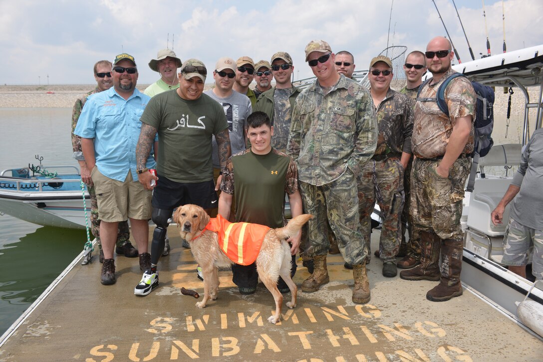 Park Rangers from the U.S. Army Corps of Engineers Nashville District and local volunteers from the Lake Cumberland pose with a group from the Wounded Warrior Outdoors program at Holcombs landing before going on a fishing trip on Lake Cumberland near Wolf Creek Dam.    