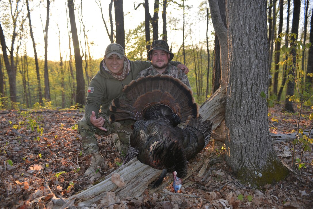 U.S. Army Staff Sgt. Kristian Cedeno from Queens, N.Y.(left) and U.S. Army Corps of Engineers, Park Ranger Daniel Clark pose with a wild turkey shot by Cedano at the Lake Cumberland State Park in Jamestown, Ky while on a fishing trip and wild turkey hunt with the Wounded Warrior Outdoors program on April 24, 2014. 