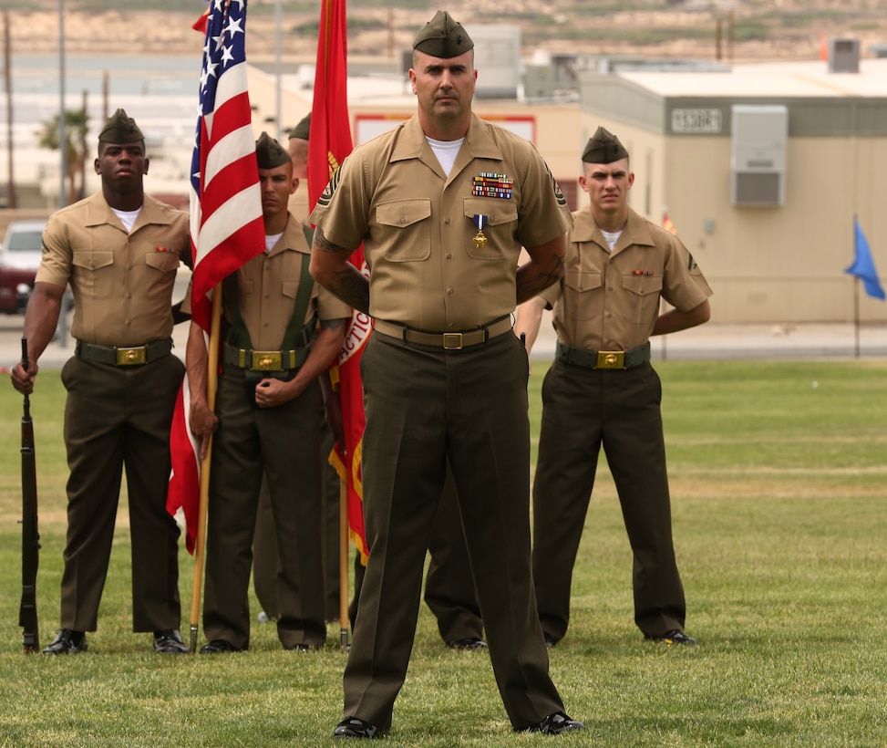 Gunnery Sgt. Richard A. Jibson, Battle Staff Training Program team member, Marine Corps Tactics and Operations Group, stands before a crowd of Marines, sailors, and their family members during a Navy Cross award ceremony held at Lance Corporal Torrey L. Gray Field April 22, 2014. Jibson was awarded for his heroic actions during a five-hour-long fire fight, which occurred May 28, 2012 in Afghanistan. (Official Marine Corps photo by Cpl. Charles Santamaria/Released)